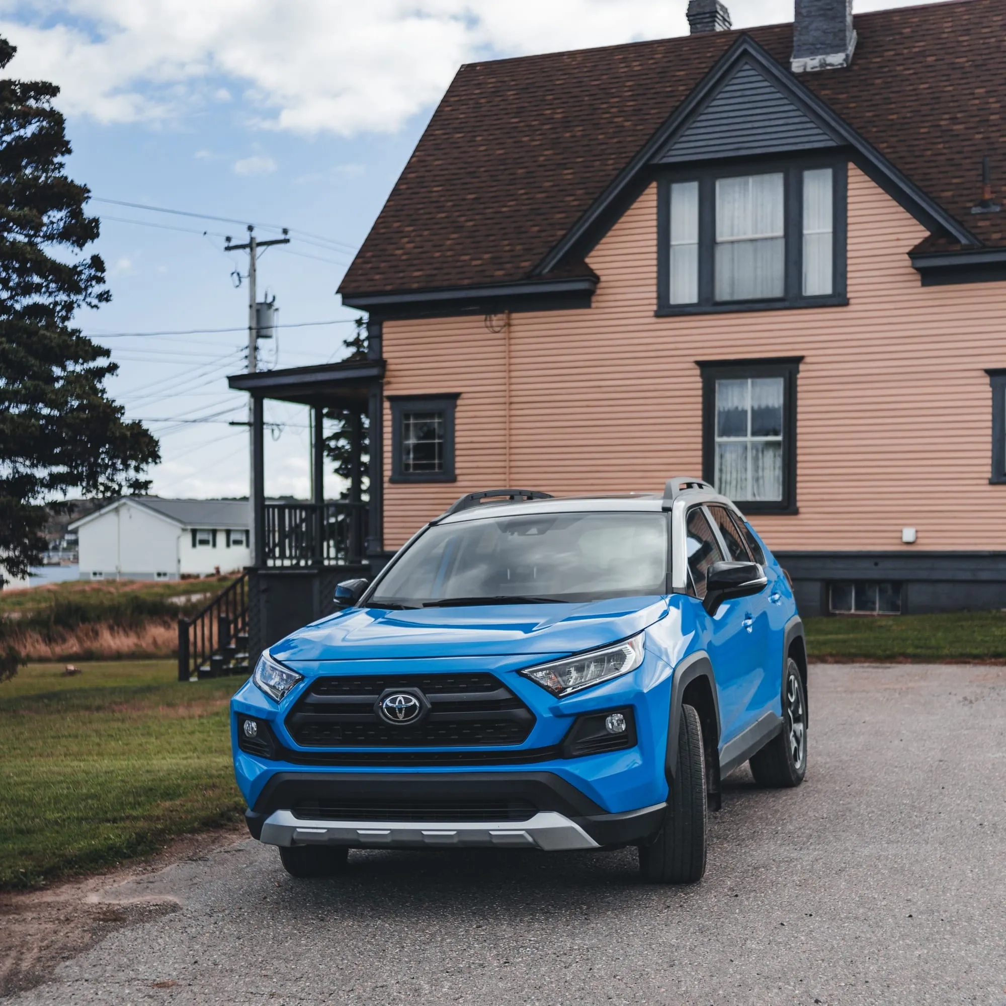 A blue Toyota SUV parked in a driveway in front of a home in Northern Colorado